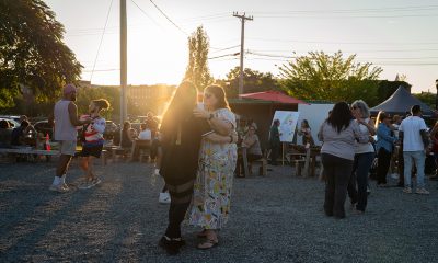 3 couples dancing outside as the sun goes down