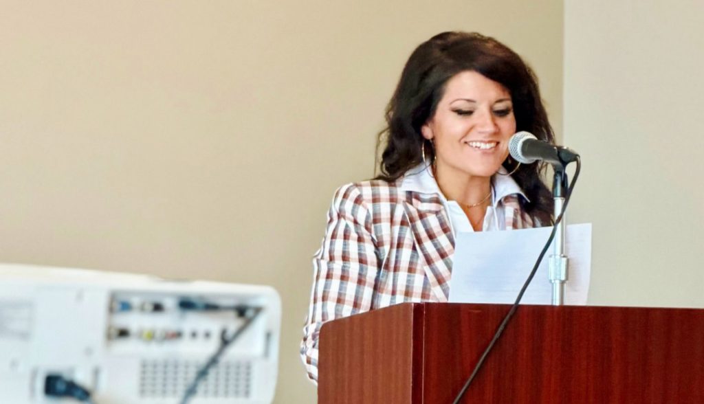photo of woman speaking at a lectern.