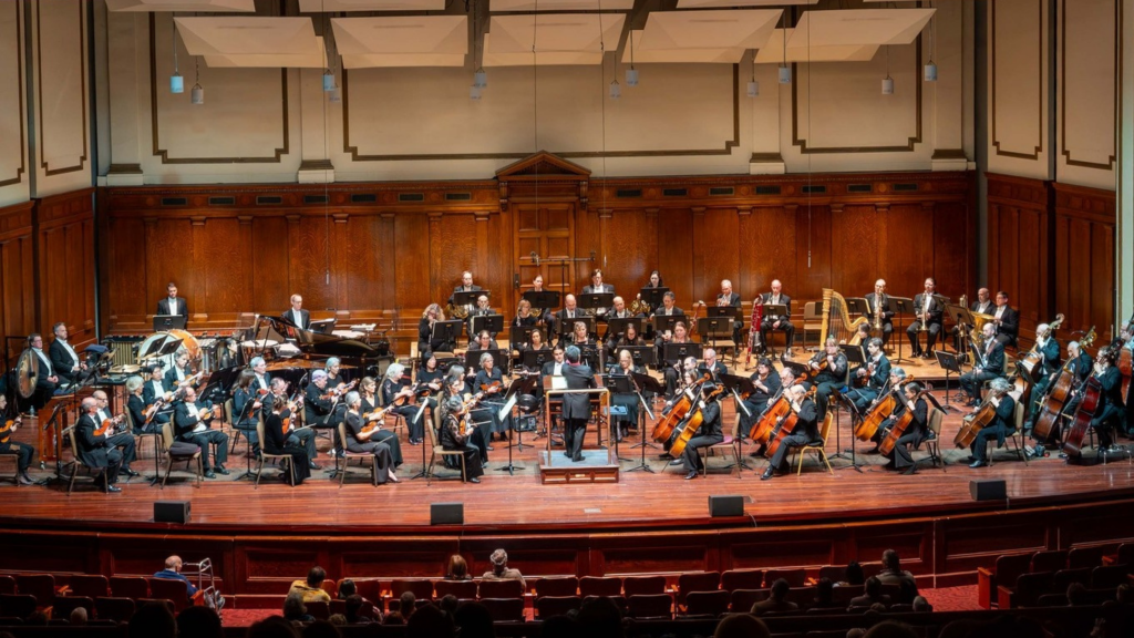 photo of a full symphony performing on stage