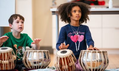 photo of two boys playing tabla drums.