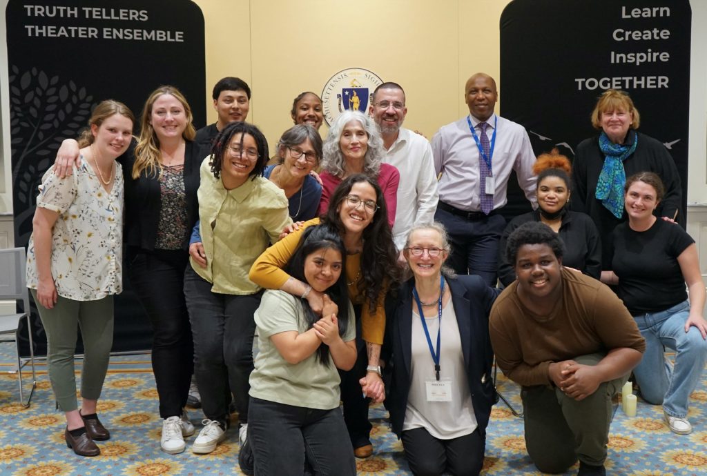 group photo of about 10 teens smiling with a handful of adults.