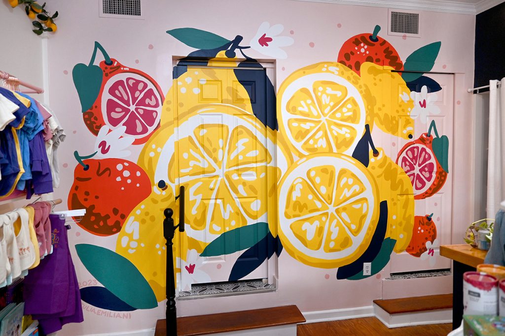 photo of a brightly painted mural featuring cut lemons and blood oranges in a clothing boutique.
