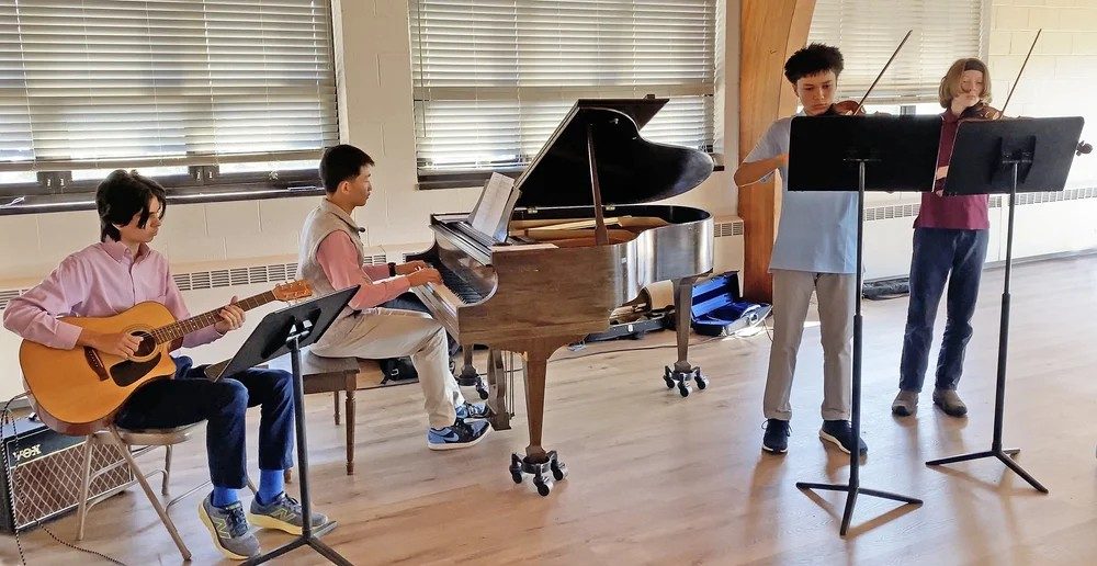 photo of 4 youth musicians performing.