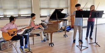 photo of 4 youth musicians performing.