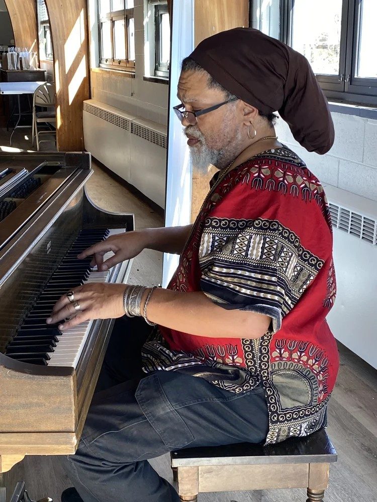 photo of a man playing the piano.