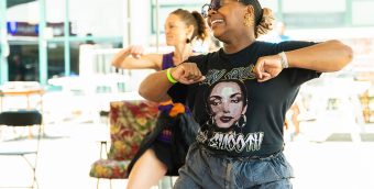 photo of 2 women dancing as part of a community dance event.