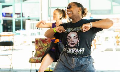 photo of 2 women dancing as part of a community dance event.