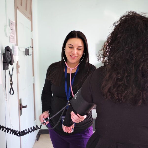 photo of a health care provider taking a patient's blood pressure.
