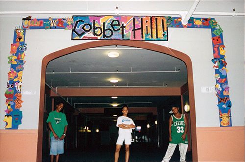 Photo of a large entryway framesd with a colorful art piece that includes the words Cobbet Hill.