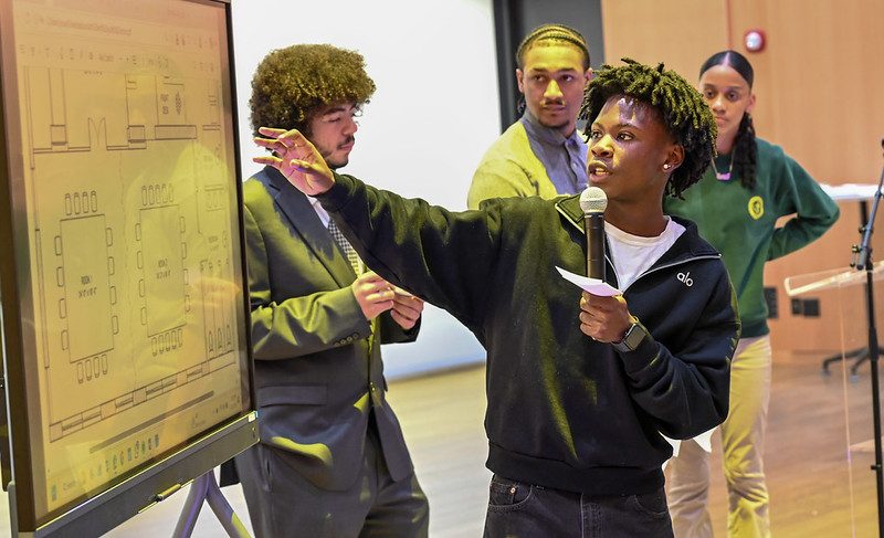 photo of a young man making a presentation to a committee