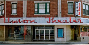 Front façade of a historic brick building with the inscription 