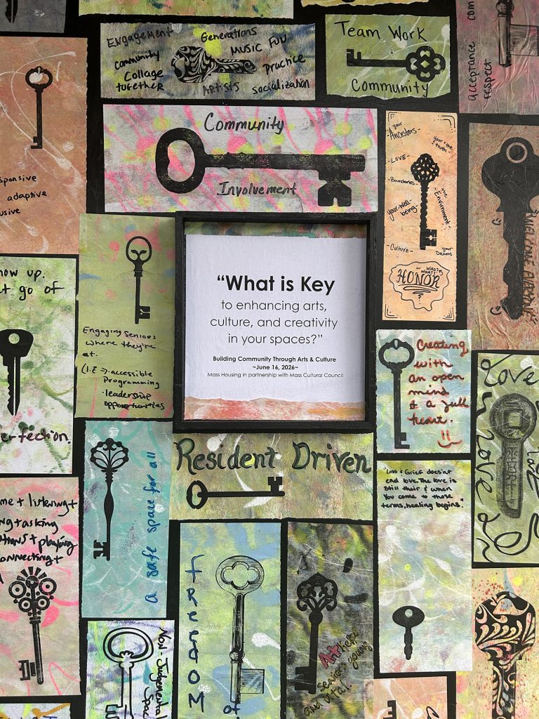 detail of a mural collage of numerous pieces of hand-painted paper with shapes of keys printed on them. Each slip of paper has a different person's handwriting stating a key benefit to successful arts programming.