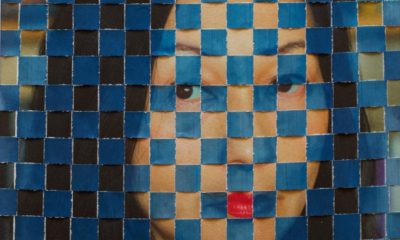 A photographic portrait of a woman, her face interwoven with blue squares.